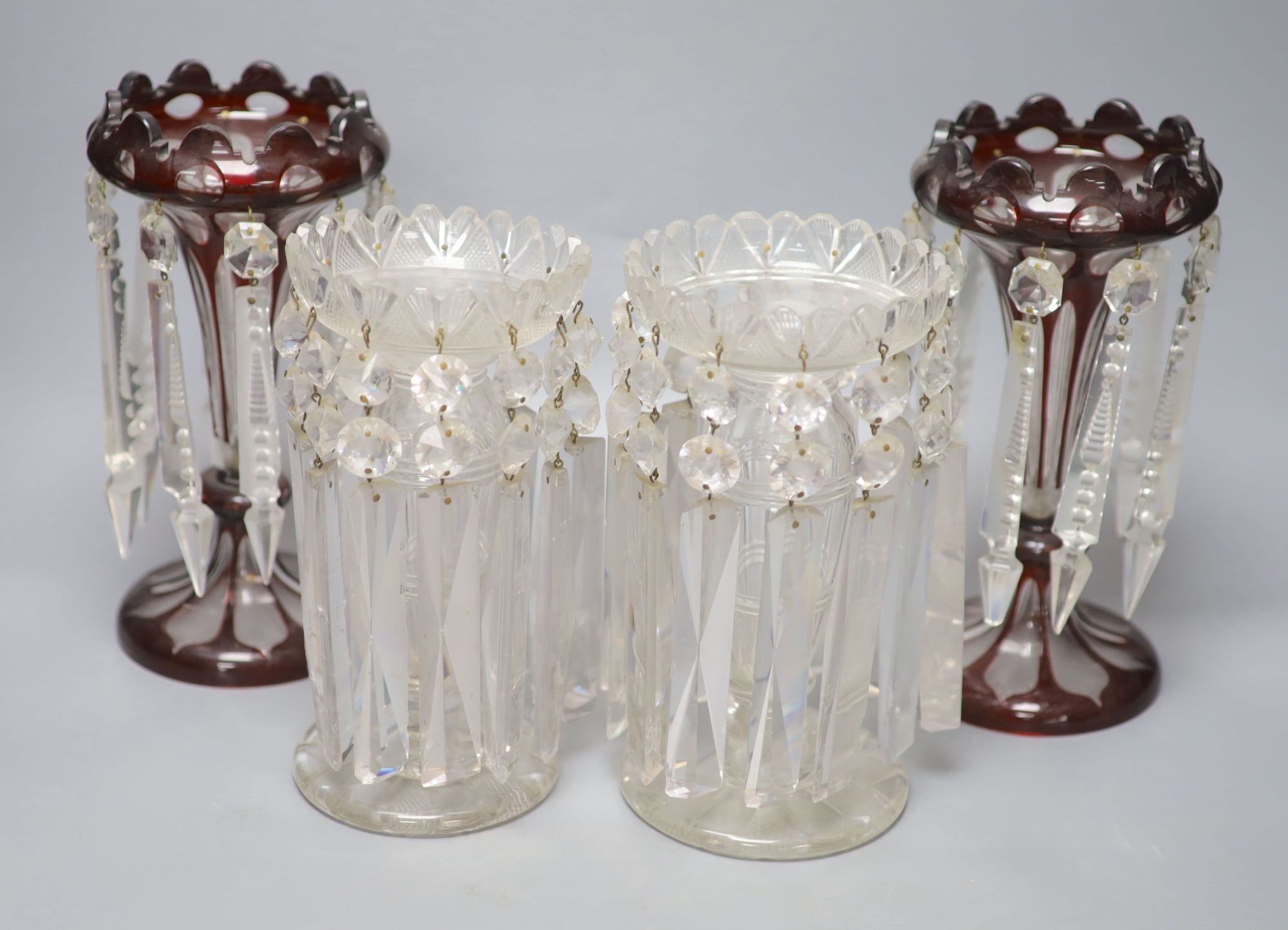 A pair of Victorian ruby overlaid table lustres and a pair of late Victorian clear glass table lustres, height 24cm